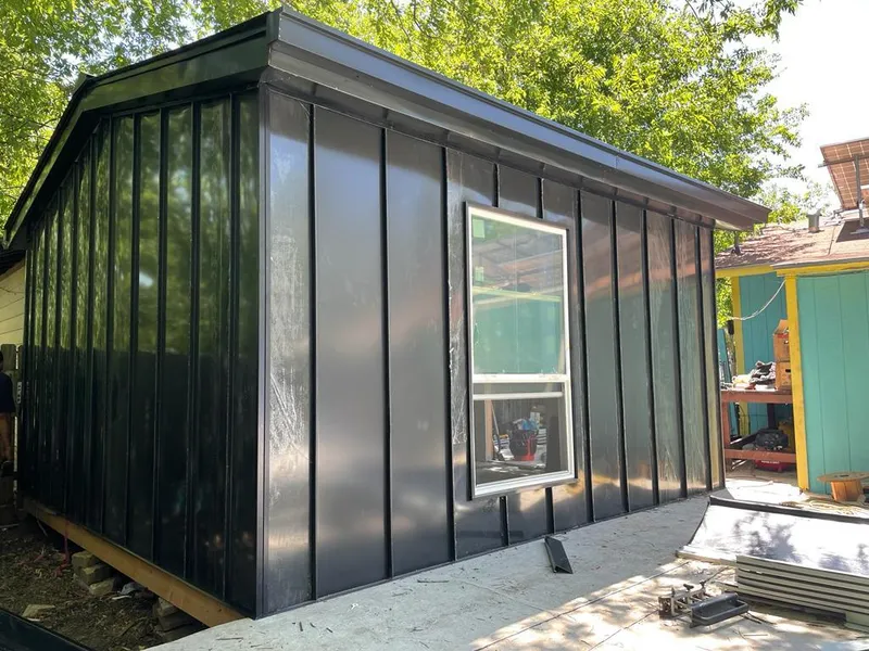 Black standing seam metal wall panels for Roof Inspection in Forsyth